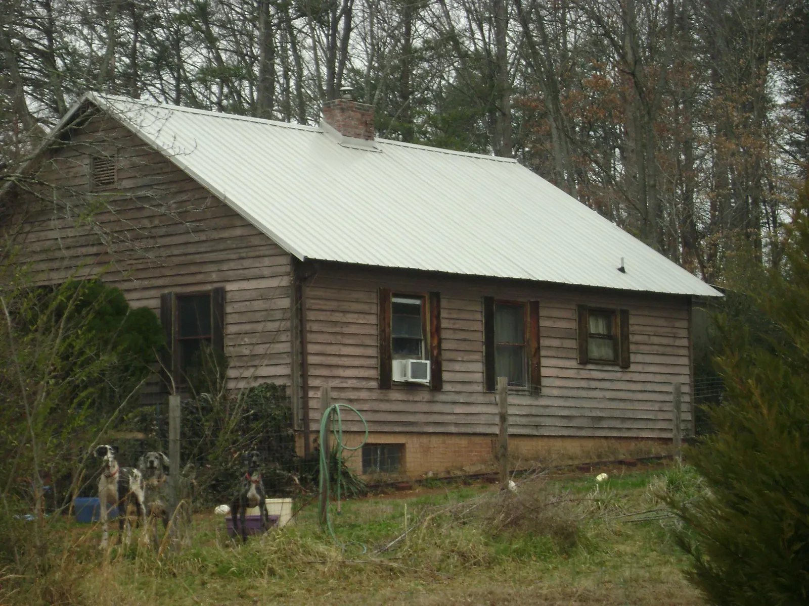 White metal roof on an old wood sided farmhouse, from a Metal Roof Installation job in Brookpark
